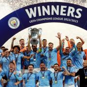 İlkay Gündoğan  lifts the Champions League trophy after Manchester City's victory over Inter Milan