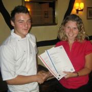 Picture of Ashley receiving his certificates from Assessor, Helen Watson.