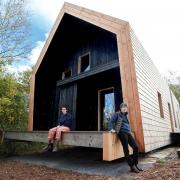 Lucinda and Rosie Leech sat outside their house near Hereford, which featured on Grand Designs