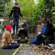 A youth worker and young men chatting in the yard at Outback, the Friday night youth project.