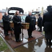 The coffins of Dick and Anne Rhodes arrive at the St John's entrance of Hereford Cathedral