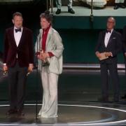 James Price (left) picking up the Oscar for Best Production Design for Poor Things