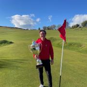 Former European Tour winner Carl Suneson pictured with the winner’s trophy on the 18th green.