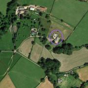An aerial view of the farm, with the barns to be demolished ringed