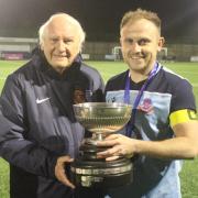Wellington captain Zac Brimble receives the Zzoomm HFA Charity Bowl trophy from Bill Shorten of the Herefordshire FA