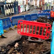 Exposed drainage in Broad Street, Ross-on-Wye, following stormwater damage to the road and pavement