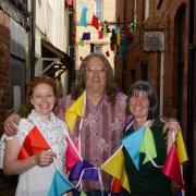 From left: Gaynor Lewin (Jumping Ships), Martin Nicholas (The Light Shop) and Val Mifflin (Parry's) from Leominster Business Group with the 'washing line' bunting on Butcher's Row. Photo: James Maggs.