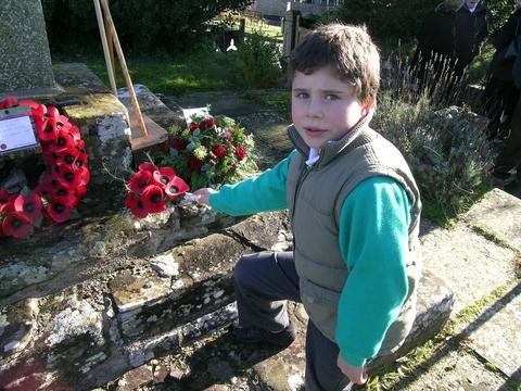 Eight year-old Thea Cosgrove laying a tribute at Gladestry war memorial on behalf of the young people of the village. Picture sent in by Ann Dean.