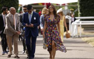 Elizabeth Hurley (right) and Henry Birtles arrives on day two of the Qatar Goodwood Festival 2022. Picture: Steven Paston/PA Wire