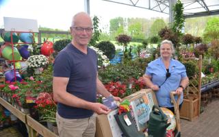Hereford Times reader John Lindsay from Holme Lacy collects his prize from Beccy Hawkins in the garden centre at Oakchurch Farm Shop.
