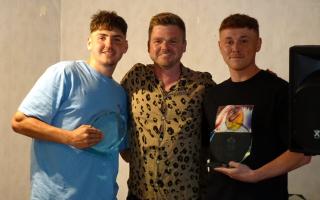 Ben Febery (left) and Tom Trigg (right) holding the first team's joint Manager's Award this season from manager Ian Merrick (centre)