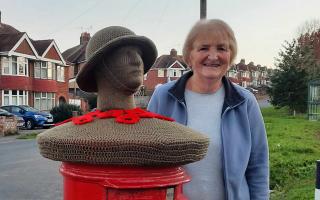 Sue Cockroft next to the Remembrance post box topper in Ross Road, Hereford