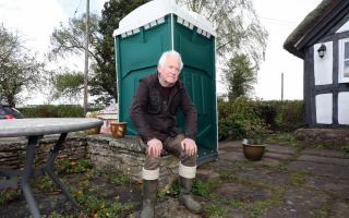 Roger Sell has to use a portable toilet due to his home having no drainage