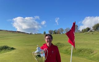 Former European Tour winner Carl Suneson pictured with the winner’s trophy on the 18th green.