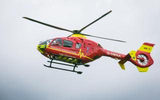 The air ambulance has been called to a field in Herefordshire after a tractor crashed into overhead power lines